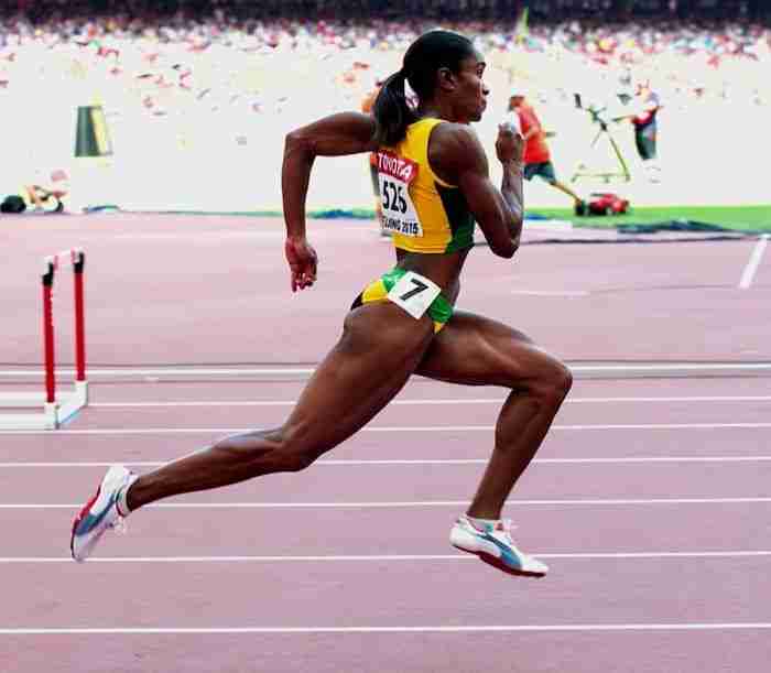 Runner demonstrating proper running form with correct posture and foot strike technique