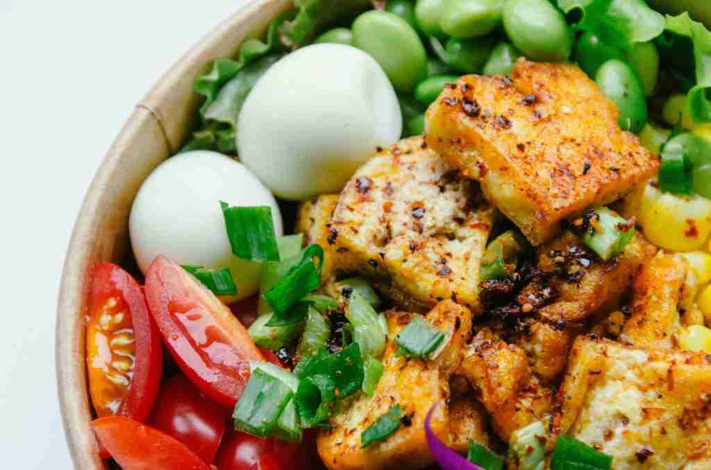 High-protein meal with chicken breast, eggs, and Greek yogurt showing protein-rich foods for women building muscle through strength training