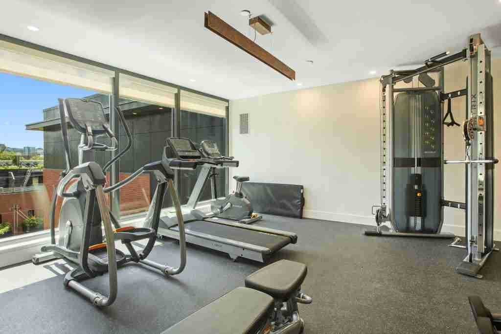 Home gym with elliptical machine in foreground and treadmill behind — treadmill vs elliptical comparison