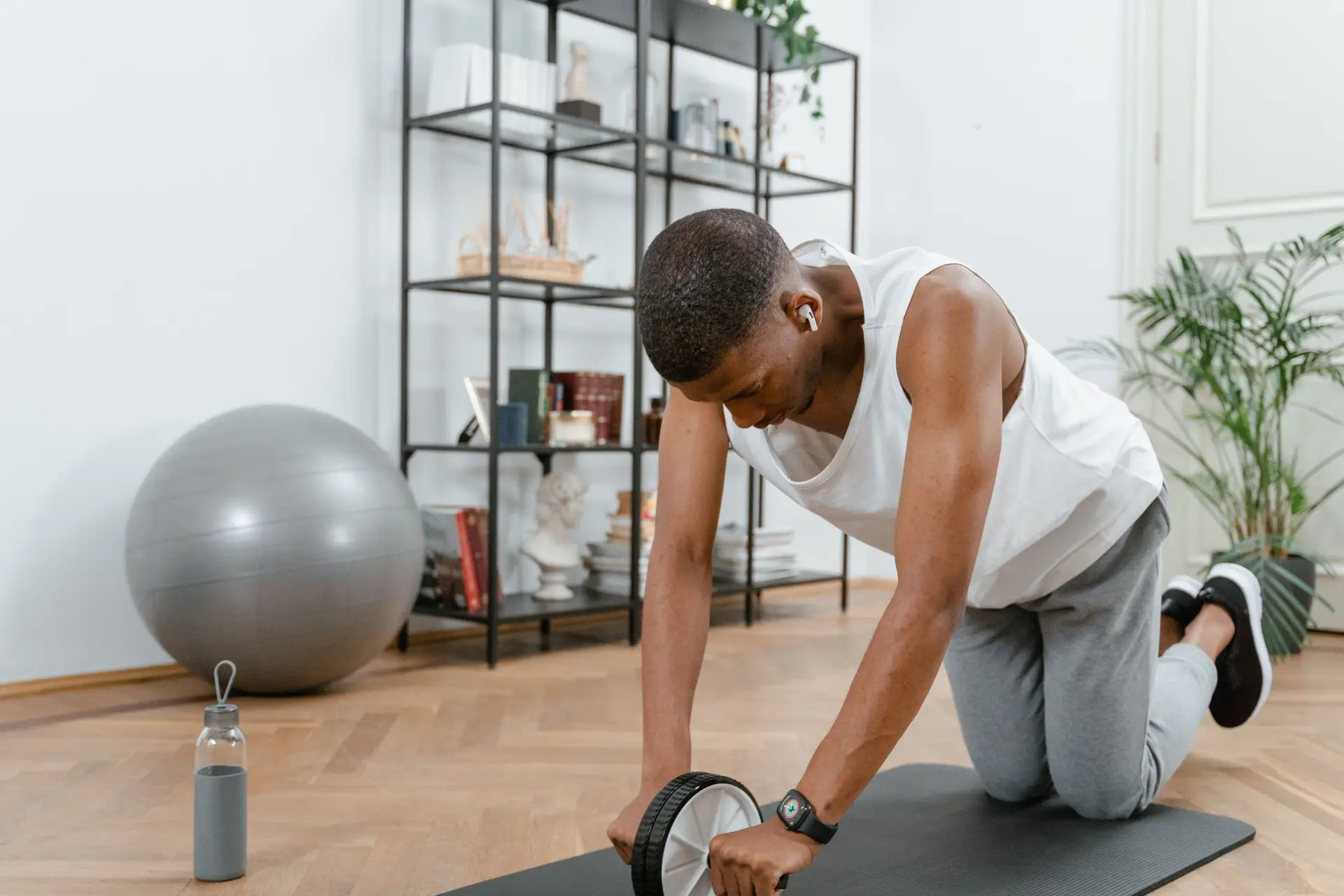 client doing ab roll exercise at home with personal trainer